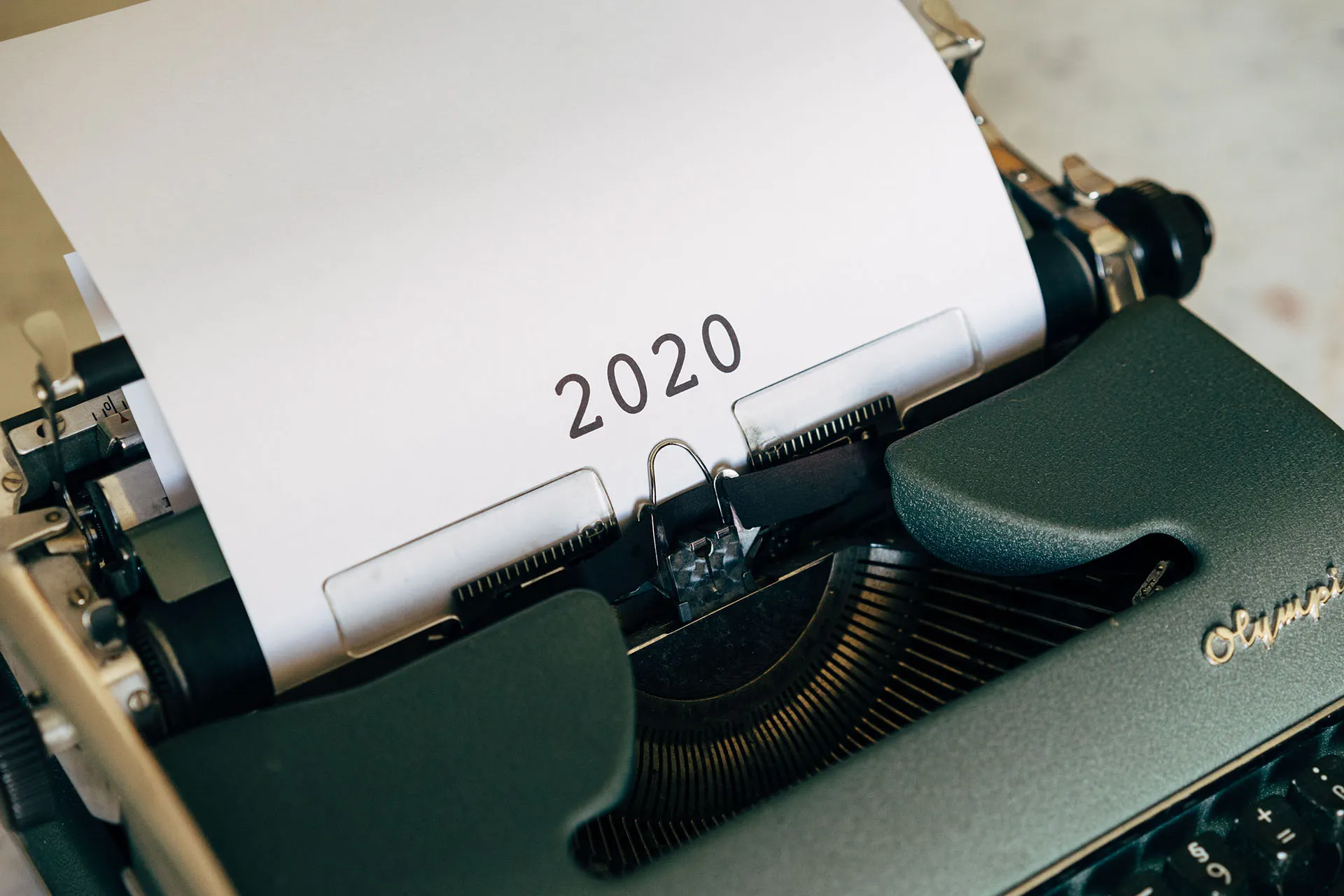 Black typewriter that has typed 2020 in the middle of a page