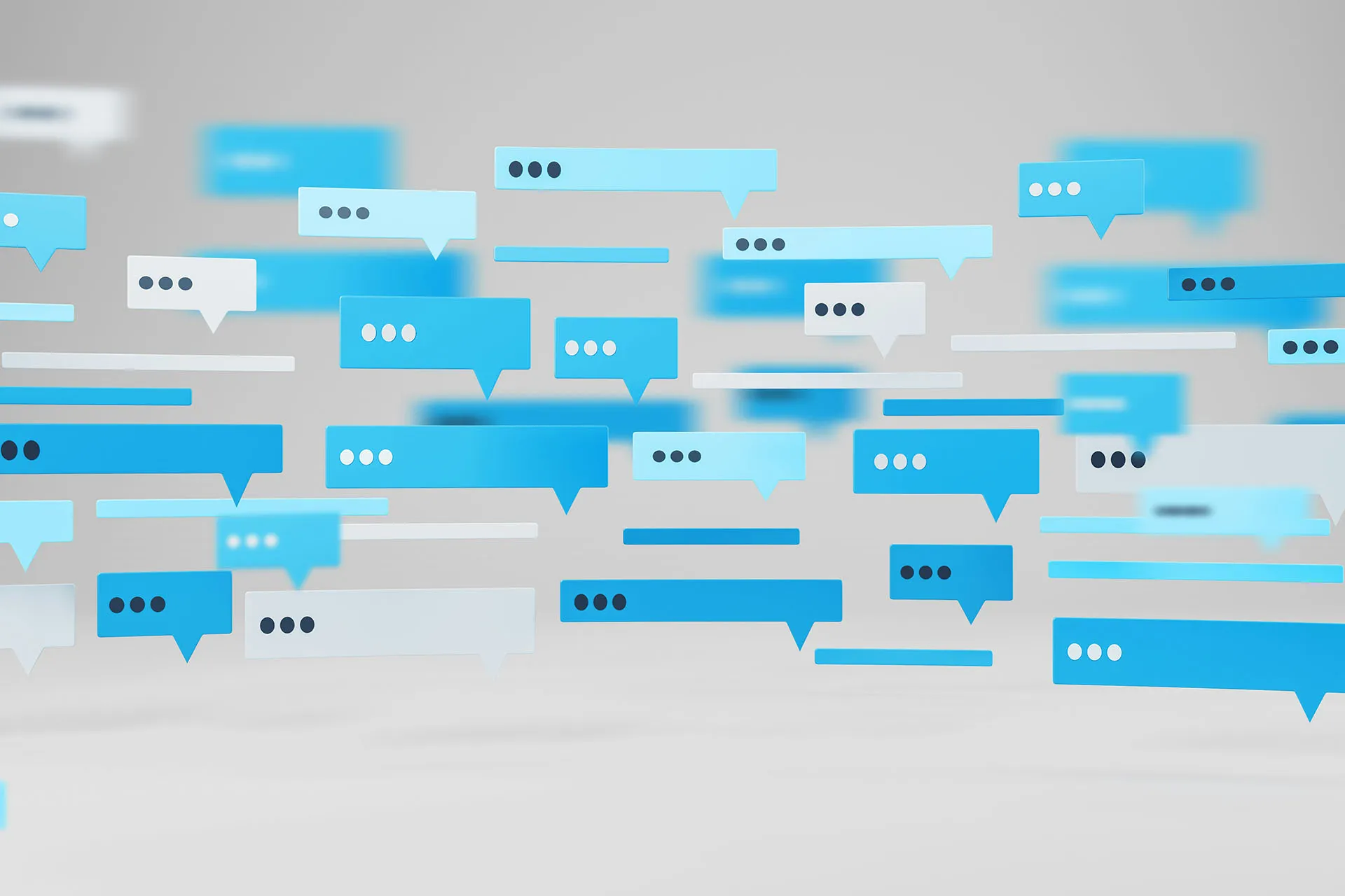 Blue and white chat bubbles floating on a light background, representing online messaging and digital communication.
