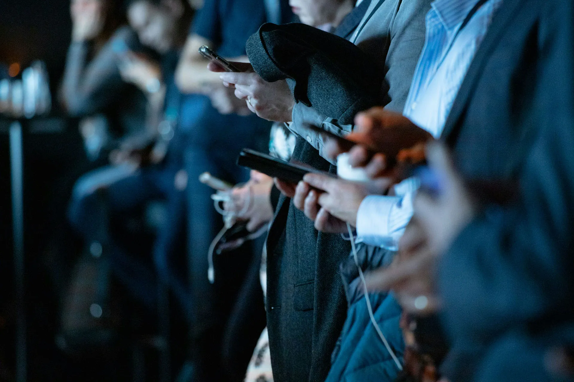  People in business attire communicating on smartphones