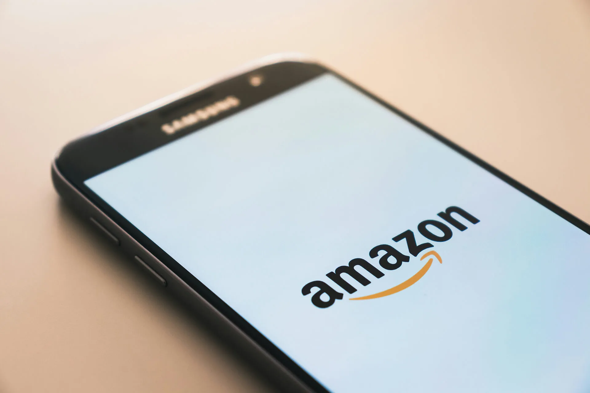 Smartphone on a desk displaying the Amazon mobile app
